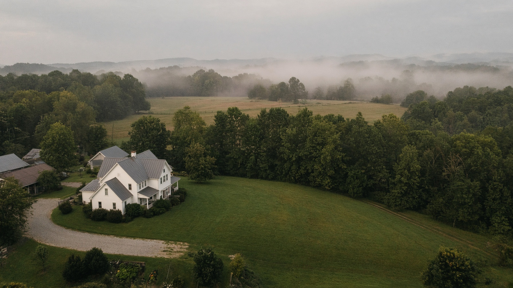 Rural Western New York property with a broad lawn and wood line